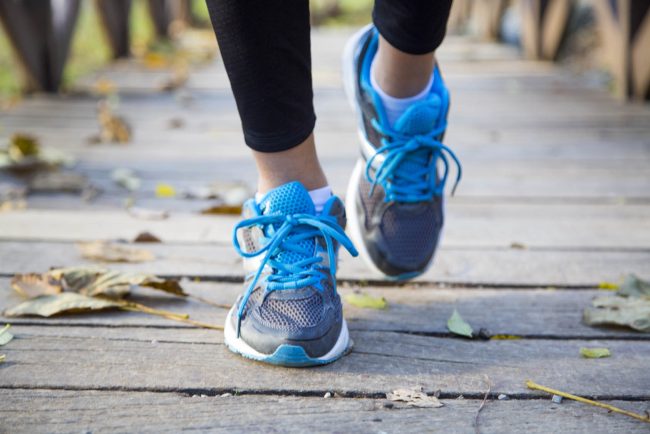 Running feet of young woman closeup on shoe